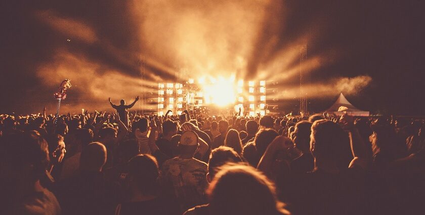 An image of a diverse crowd enjoying live performances at a major music festival in the USA.