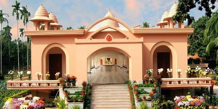 Nimpith Sarada Ashram building with temple architecture surrounded by greenery.