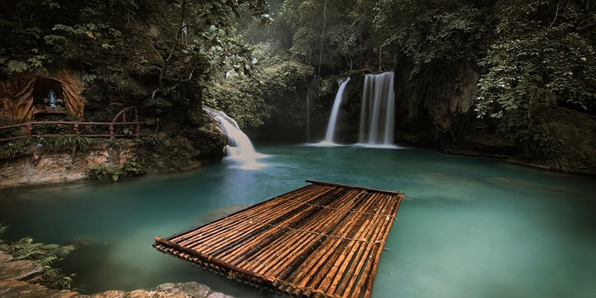 Cascading turquoise waterfalls surrounded by lush tropical forest