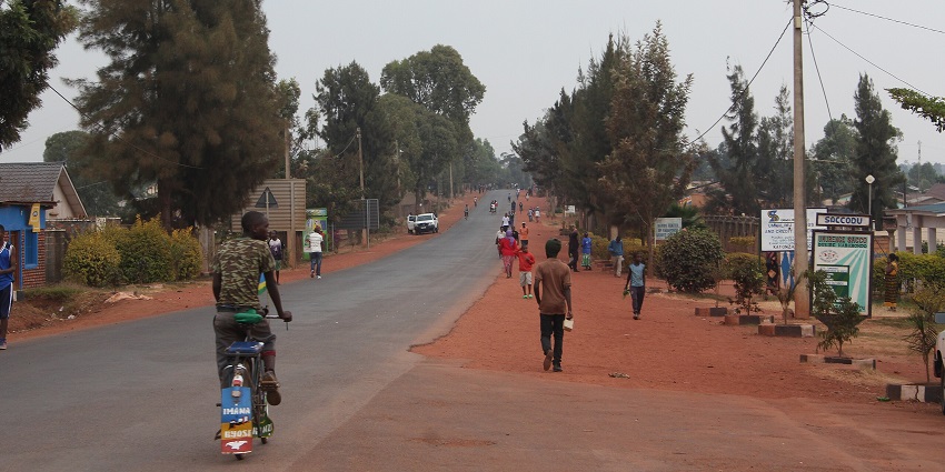 A man cycles through his way on a less busy road in Kayonza District near Akager, Rwanda.