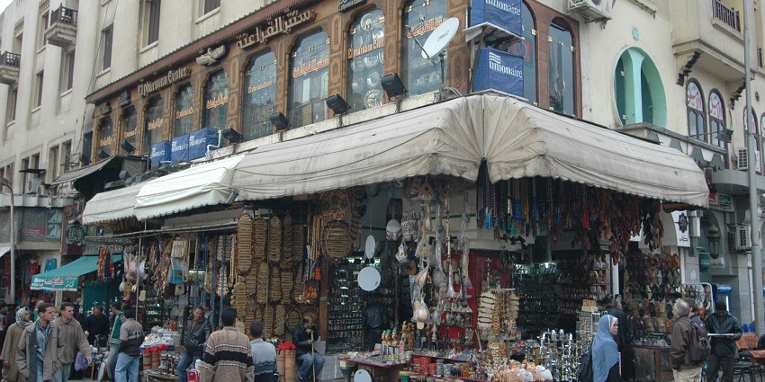 Multiple unique shops and buildings in Khan El Khalili Bazaar and people exploring.