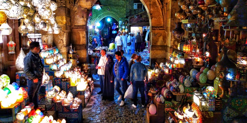 Khan el Khalili market at night with sellers selling unique colourful lamps and people