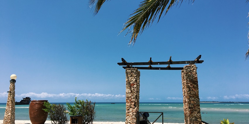 A gorgeous view of Kunduchi Beach, which has a small stone wall around its border.