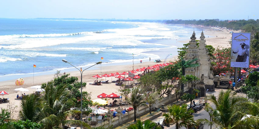 A view of waves crashing at a less busy Kuta Beach, a place to visit on the Bali travel guide.
