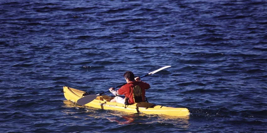 An image of a kayaker paddling in Lake Powell, one of the best places for kayaking in the USA.