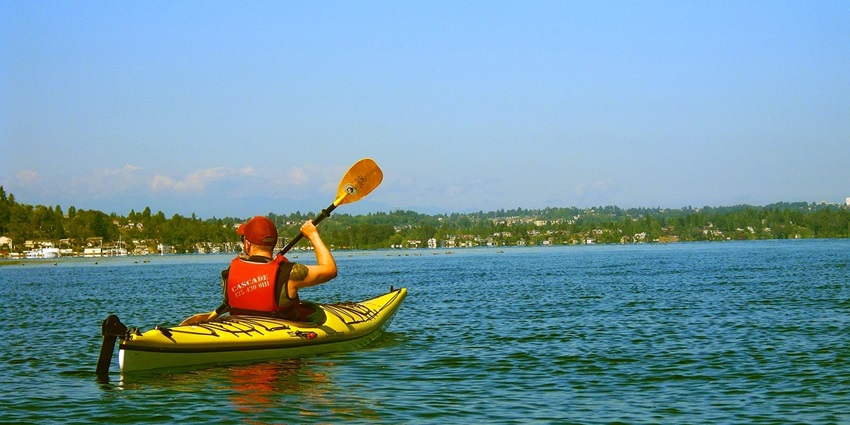 An image of a kayaker paddling in Lake Tahoe, one of the best kayaking places in the USA.