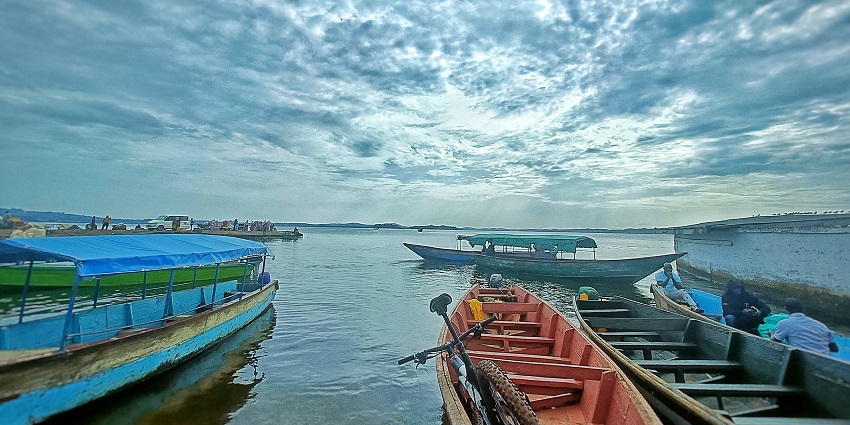 The morning view of Lake Victoria is featuring fishing boats under a cloud-filled sky