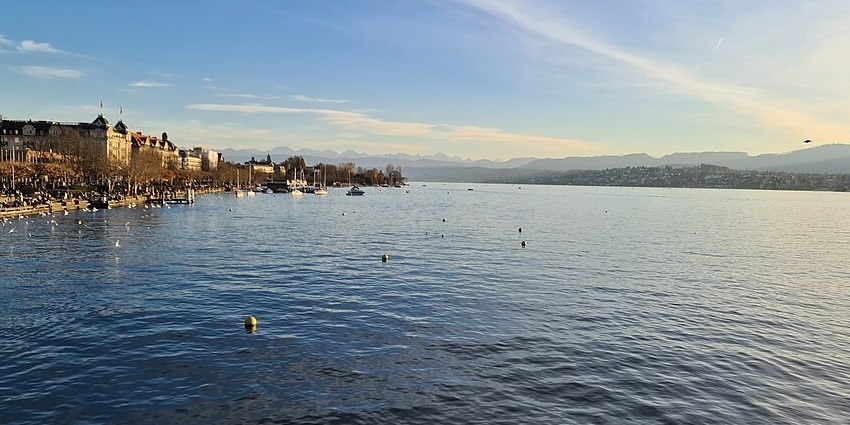 Sparkling lake surrounded by the cityscape and scenic hills