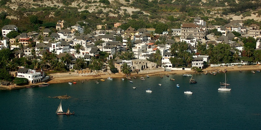 A panoramic view of Lamu Island features elegant houses and an uneven landscape
