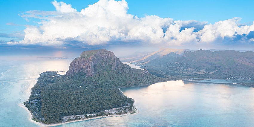 Le Morne Brabant peninsula from the top with big mountains, hills and bright blue sea.