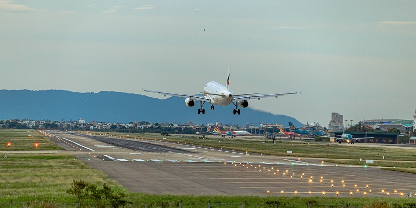 A view of an Airplane landing at the airport on a clear day with a runway at one of the airports in Chicago.