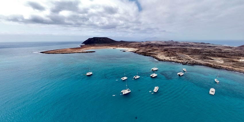 A view of a small uninhabited island off Fuerteventura, ideal for hiking and exploration.