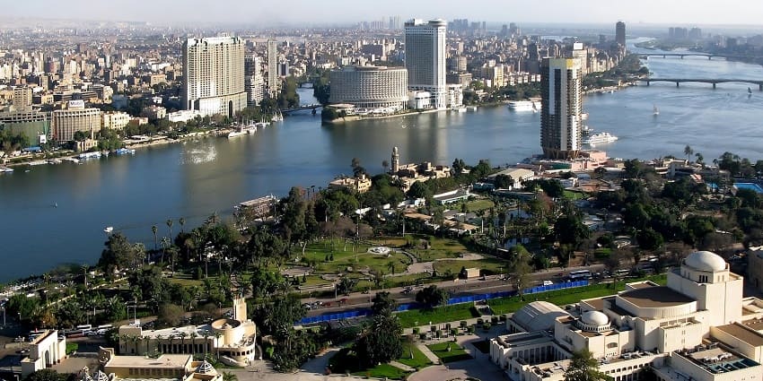 An aerial view of Cairo across which a river is flowing, parting the city into two parts