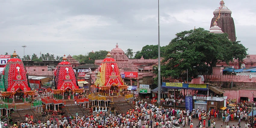 Thousands of people flock near the decorated temple chariots during Rath Yatra in Puri, Odisha.