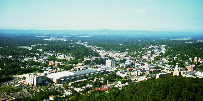 Aerial view of Hot Springs, Arkansas, showing the town and surrounding greenery.