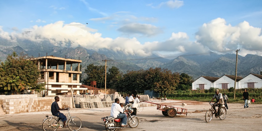 Morogoro town in Morogoro region with people riding motorcycles and distant mountains.