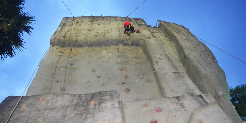 A picture of a person indoor rock climbing in Mumbai, India.