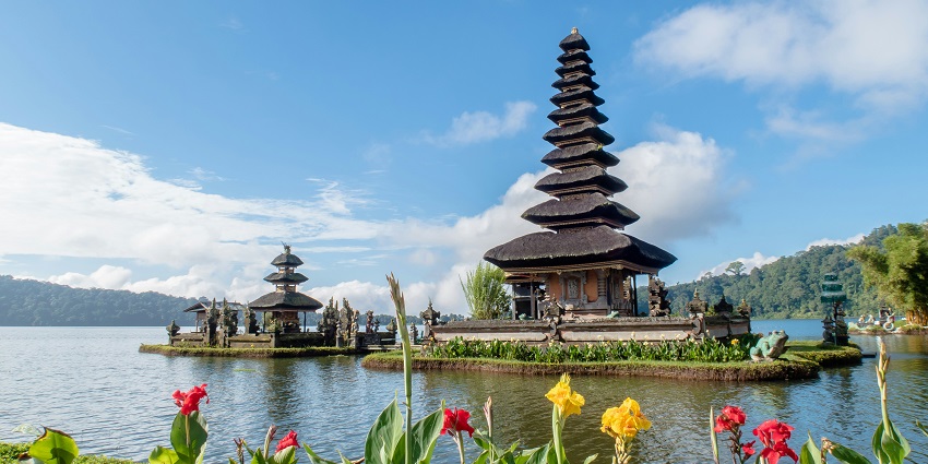 A group of artists engaged in wood carvings to create beautiful artefacts in Bali, Indonesia.