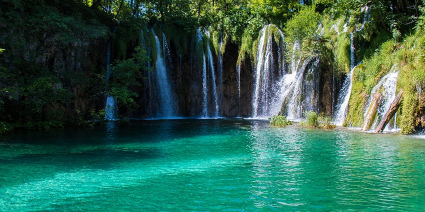 Plitvice Lakes National Park features stunning waterfalls and crystal-clear turquoise waters.