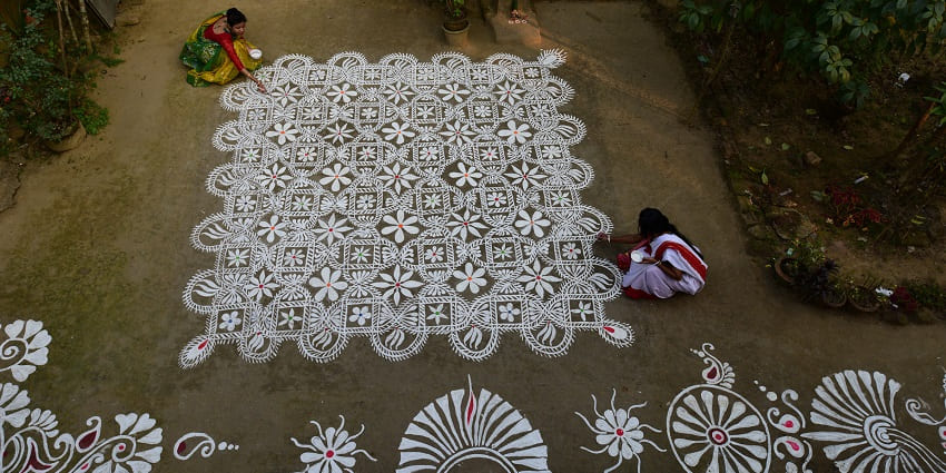 women making rangoli for the Makar Sankranti celebration