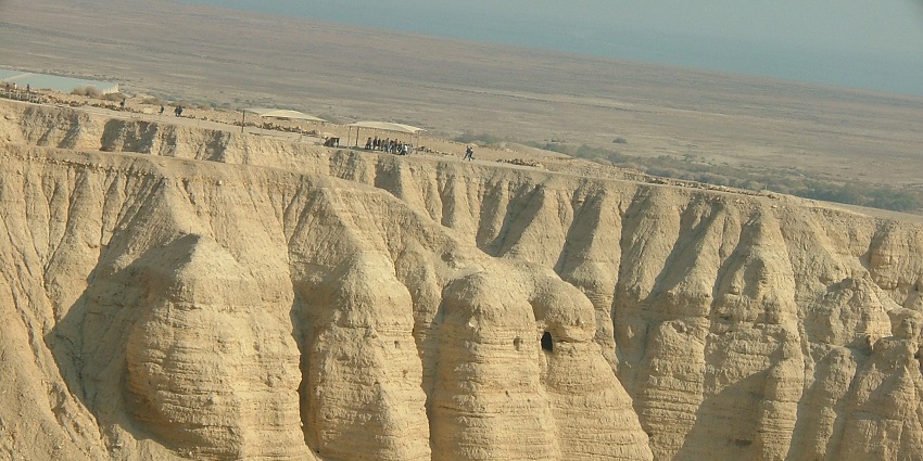 Qumran Caves with a stunning desert backdrop near the Dead Sea.