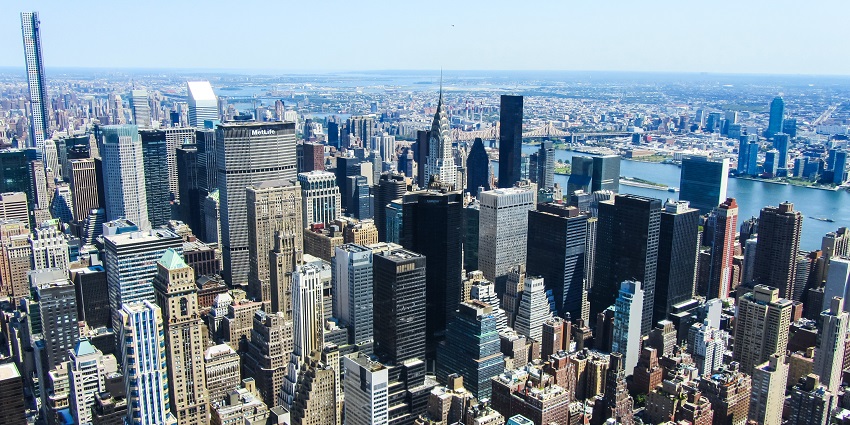 A skyline view of Manhattan, New York City, featuring modern skyscrapers and iconic buildings.