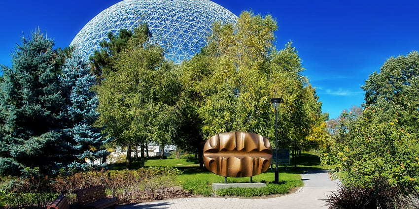 An image of Parc Jean-Drapeau with stages, art installations, and attendees during festival.