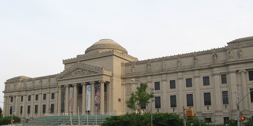 Exterior view of the Brooklyn Museum with its grand columns and wide steps.