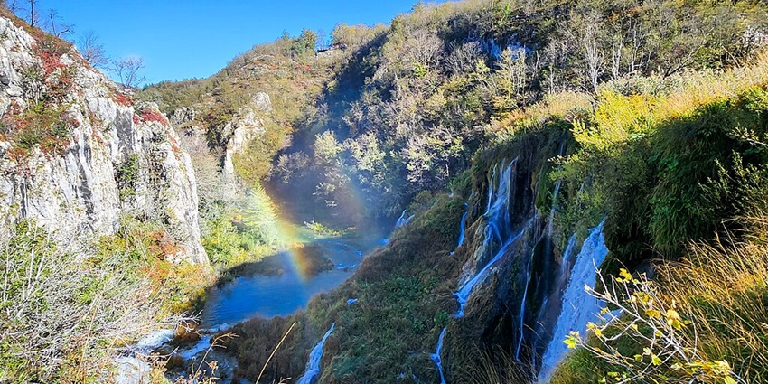 A scenic view of the rainbow at Plitvice Waterfalls in Croatia within the National Park.