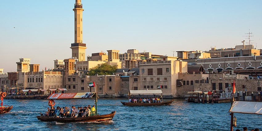 Groups of tourists enjoy boating in Dubai Creek, a water channel connecting to the Persian Gulf.