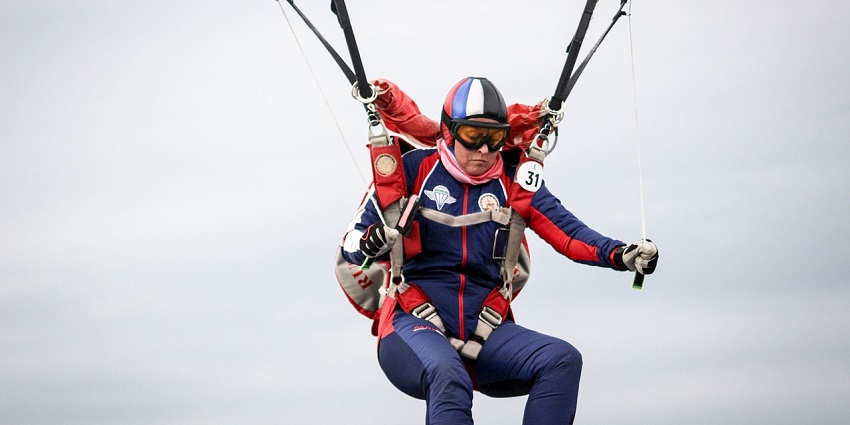 An image showing a woman mid-air during freefall, emphasising the best time for skydiving in London