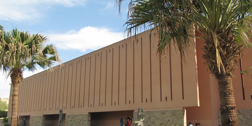 Museum of Luxor with modern Egyptian architecture, people visiting and a couple of statues