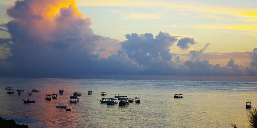 Several boats are present near the shore of Malindi, witnessing the breathtaking sunset