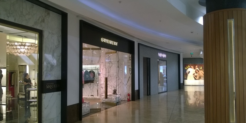 A picture of a corridor of a shopping mall in Ayodhya with a luxury store visible