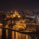 Senglea in Malta at night with well-lit buildings and cars parked on distant streets