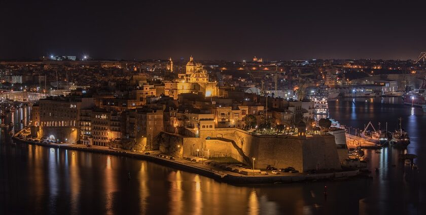 Senglea in Malta at night with well-lit buildings and cars parked on distant streets