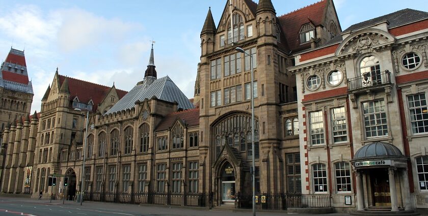 An image showing the exterior of the Manchester Museum, highlighting its historic architecture.