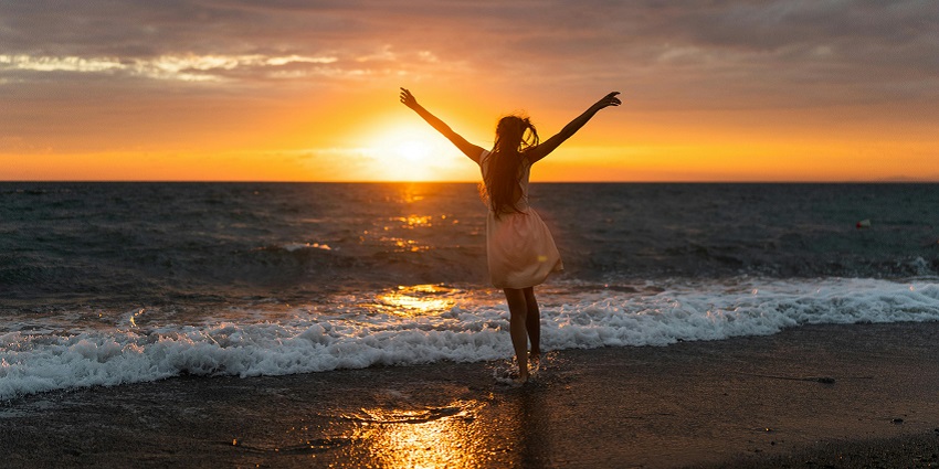 A view of of a woman enjoying the sunset in beach with scenic views in Las Vegas