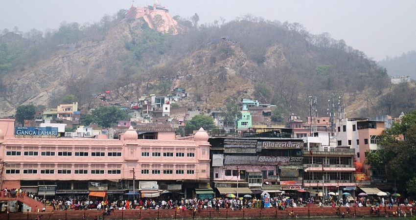 Image of Mansa Devi Temple, Haridwar and people strolling around the road