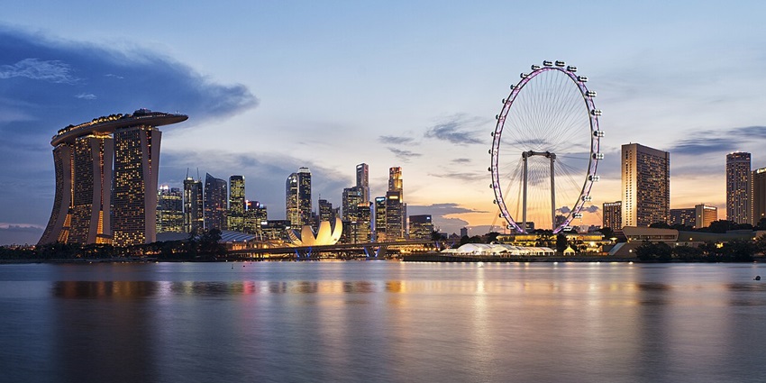 Marina Bay with popular Marina Bay Sands on the left and a giant wheel on the right in Singapore.