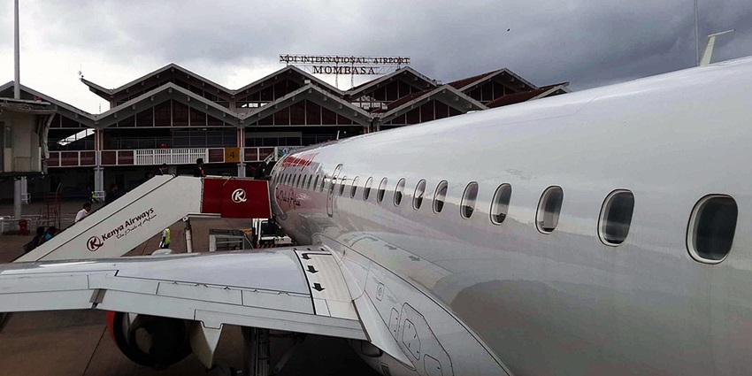 A view of the Mombasa Airport showing the name sign and close view of the Kenya Airways flight