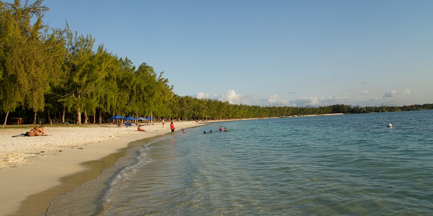 People spend their time with family and loved ones beside the shore of Mont Choisy Beach.
