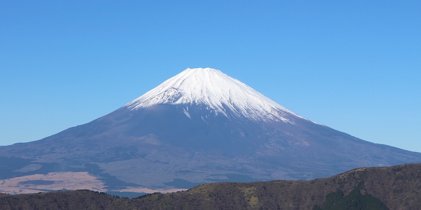 A distant view of volcanic Mount Fuji shows a snow-covered area near its mouth in Tokyo