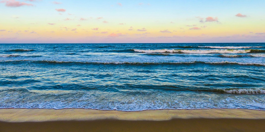 Beautiful sunset over Muchangpo Beach, casting vibrant colors on water to witness.