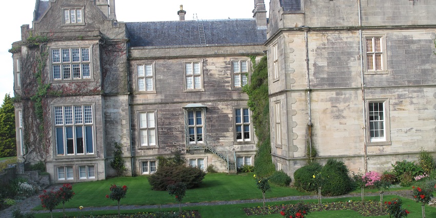 An image of Muckross House, a Victorian mansion, overlooking Muckross Lake in Killarney.