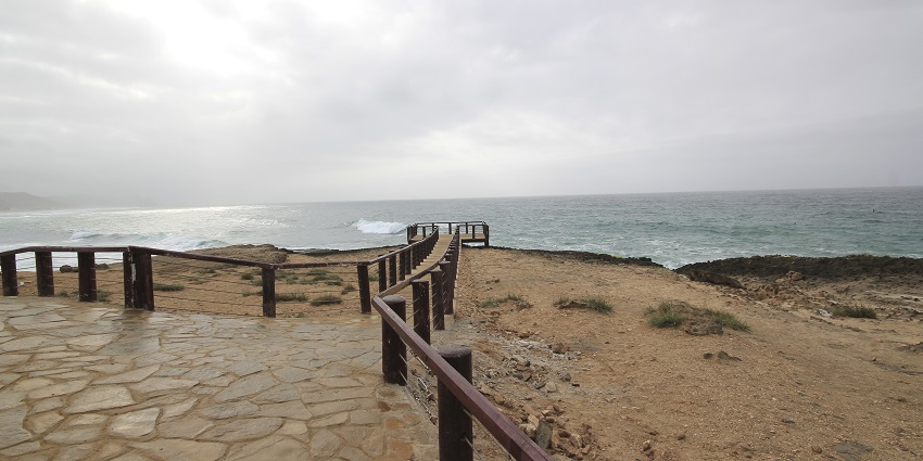 A glimpse of scenic Oman beaches with dramatic cliffs, clear waters, and serenity.