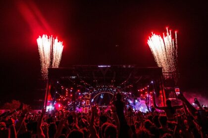 An image of the festival-goers having fun at music events, surrounded by vibrant lights