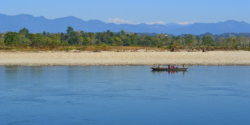 Tourists crossing the river with forest guards, at the Nameri National Park, Tezpur.