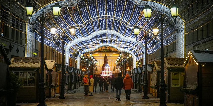 Image of a vibrant lighting street and people walking around with their families
