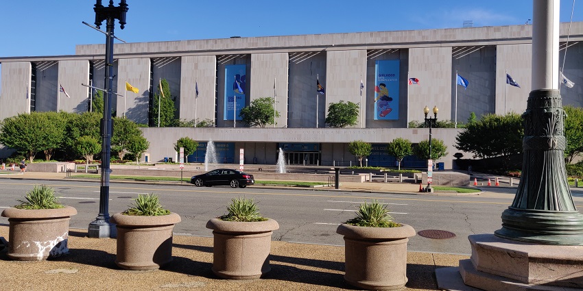 Exterior of the National Museum of American History with columns and the American flag